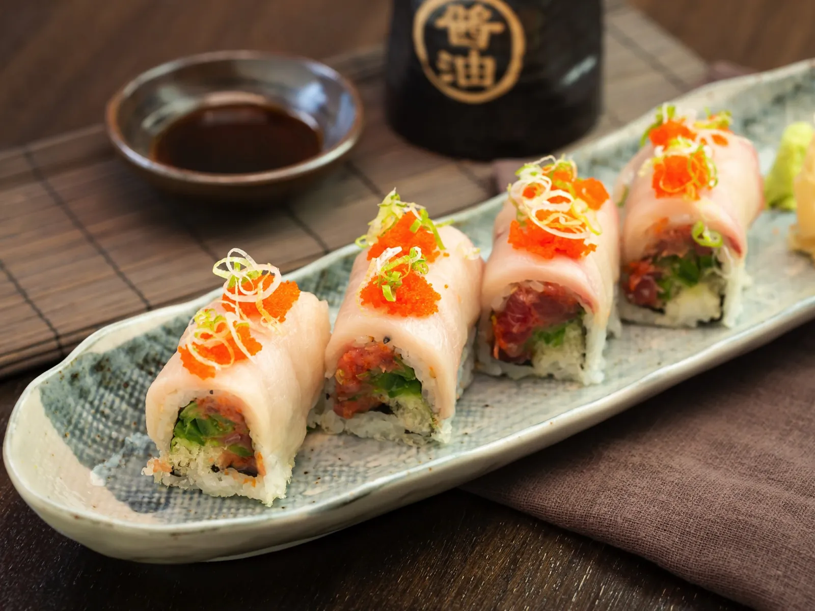 Pink soy-paper roll topped with tobiko at Kikoo Sushi