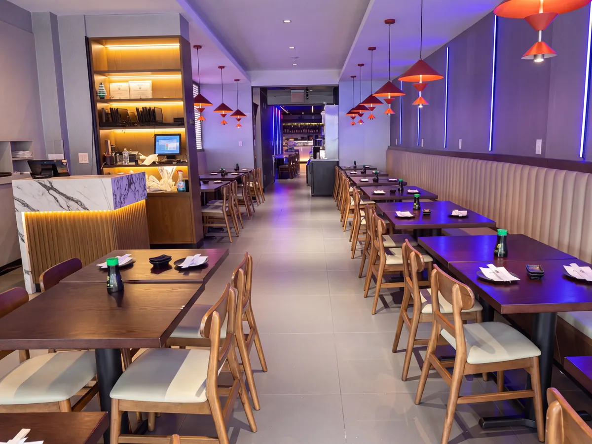 Dining room with booths and host counter at Kikoo Sushi East Village