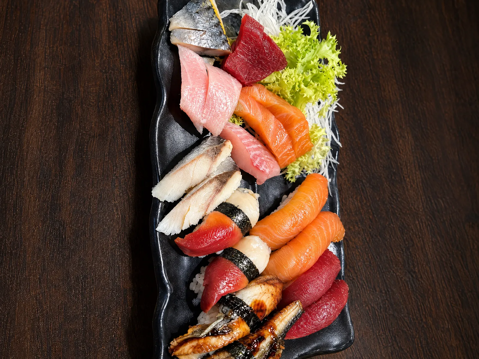 Sashimi and nigiri platter on black slate at Kikoo Sushi East Village